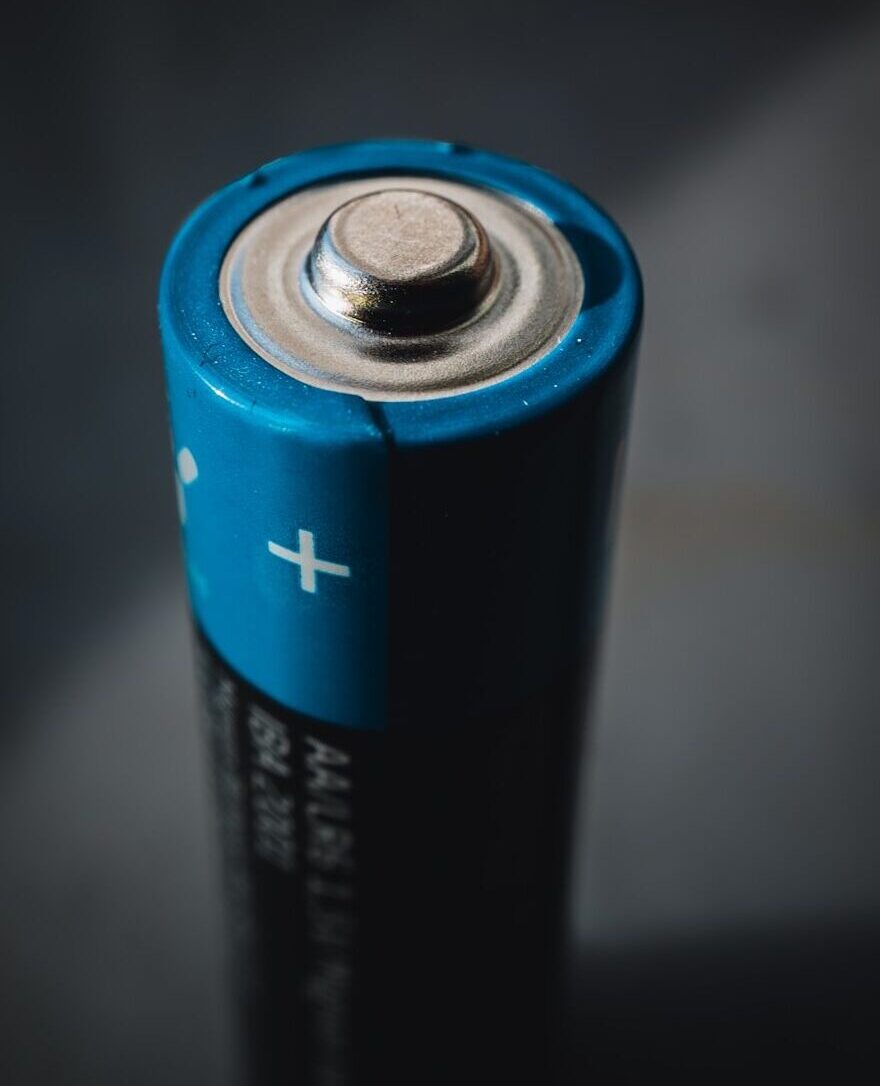 blue and black can on black surface