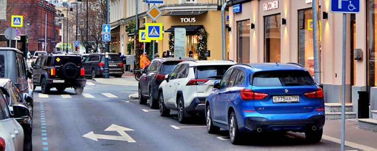 Street with parked cars and buildings in moscow